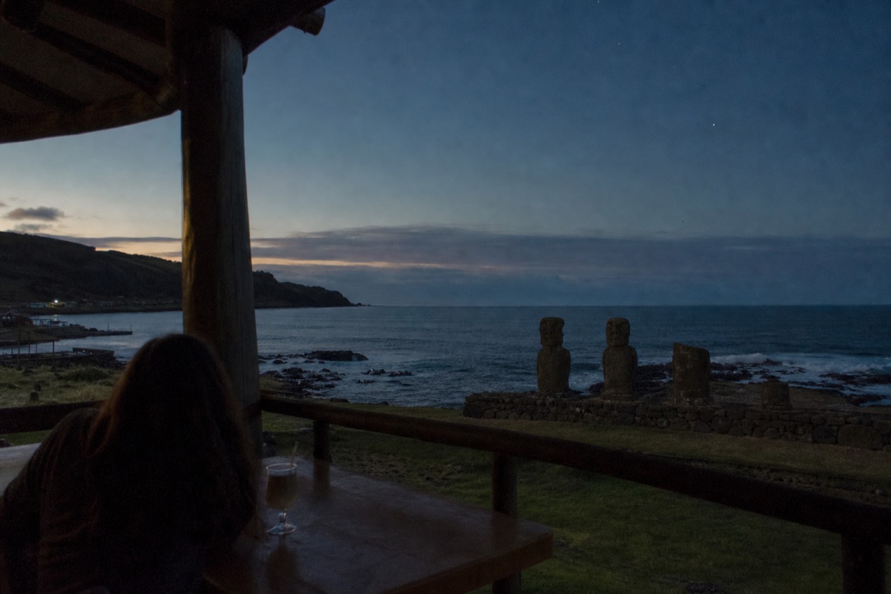 Guesthouse terrace at dusk on Rapa Nui with the ocean beyond and the first stars showing over the water