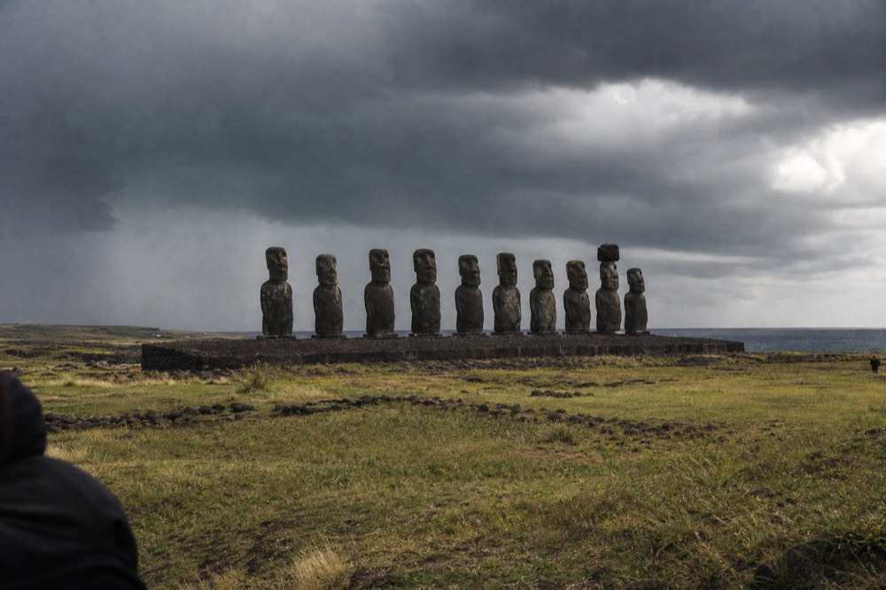 Restored platform of standing moai photographed from the open ceremonial ground in front of it