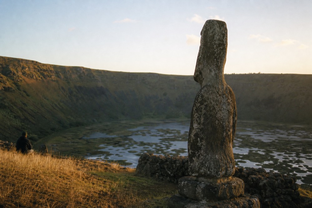 Reed-covered water filling the wide floor of the Rano Kau crater with steep green walls rising around it