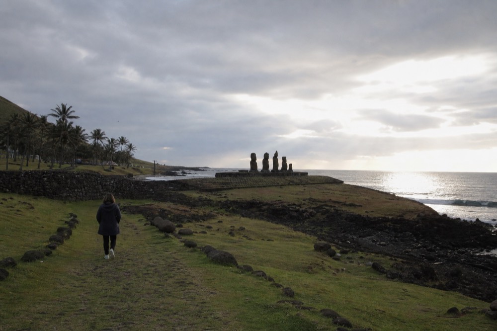 Grass path leading north out of town toward the Tahai platform with the sea catching evening light